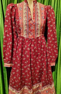 1970’s burgundy calico floral Gunne Sax style Cottage Core prairie cotton long sleeve dress.Can fit most sizes since it ties in the back, see photo of untied dress. Most dresses in this style are extra small, but not this one!PTP 39"High waist at seam 37" but can be tied as small as desired.Length 44"Very good condition. Style Cottage, Gunne Sax, Prairie Dress, Cottage Core, Cottage Style, Vintage 70s, Sleeve Dress, Dress Shop, Cottage