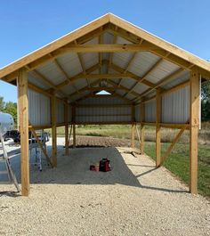 a large metal building sitting on top of a gravel field