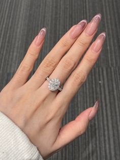 a woman's hand wearing a diamond ring