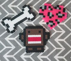 three pieces of crafting made to look like pixel characters on a gray and white background