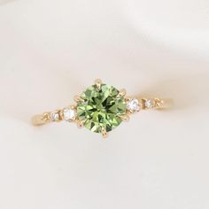 an engagement ring with a green and white diamond