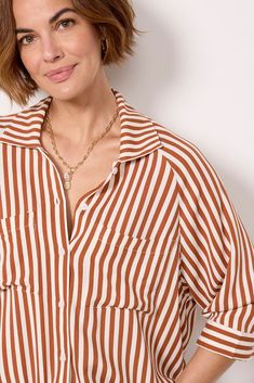 A drawstring hem adds a unique flair to this classic button-down by LNA. Crafted in lightweight fabric, this striped top features a collared neckline, relaxed fit, and two chest pockets. Pair with your favorite cutoffs and sandals for a polished summer look. | LNA Women's Alpine Drawstring Button Down Shirt, Size Medium, Orange Casual Vertical Stripes Blouse For Fall, Striped Collared Shirt For Fall, Fall Striped Collared Shirt, Casual Collared Blouse With Vertical Stripes, Striped Relaxed Fit Button-up Blouse, Relaxed Fit Vertical Stripes Button-up Blouse, Striped Collar Button-up Blouse In Relaxed Fit, Relaxed Fit Blouse With Striped Collared, Relaxed Fit Blouse With Striped Collar