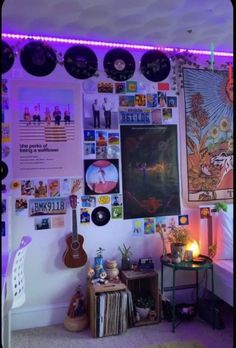 a bedroom with purple lights and pictures on the wall above it, along with a bed