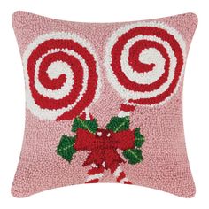 a pink pillow with candy canes on it