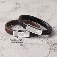 "Create a beautiful bespoke gift by capturing two fingerprints on this simple and stylish braided woven leather bracelet. Also, you can add a short text as a memory reminder of them. P R O D U C T ∙ I N F O * Materials: 2 stainless steel magnetic clasps & braided leather. * Clasps size are approx 15/16'' x 3/8'' (long side) and 3/8'' x 3/8'' (short side). * Word limits: 2-3 words for short side. * Sizing: We have four sizes: Size S: wrist size (5 1/2 - 6 1/3 inches; 14-16cm) Size M: wrist si Modern Rectangular Leather Bracelet For Gift, Modern Rectangular Leather Bracelet As Gift, Modern Rectangular Leather Bracelet Gift, Gift Braided Leather Bracelet, Modern Braided Jewelry Gift, Modern Braided Jewelry As A Gift, Modern Braided Jewelry As Gift, Modern Braided Jewelry For Gifts, Modern Braided Jewelry For A Gift