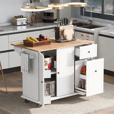 a kitchen with an island, sink, and counter top in the middle of it