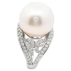 A lovely South Sea cultured pearl takes center stage. It measures 15mm and has excellent lacre quality and luster which makes the pearl glow in the light along with a soft pink overtone. It is complemented by 1.15 carats of fancy and round brilliant-cut diamonds set around the ring and creating two delicate butterflies on the sides of the pearl. Made in 18k white gold and ready to be worn. Ring Size 6.75 Weight: 11.9 grams Gold Butterfly Ring, Butterfly Ring, Sea Pearl, South Seas, South Sea Pearls, Sea Pearls, Gold Butterfly, Pearl Diamond, The Pearl