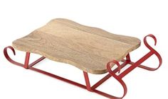 a wooden table with red metal legs and a stone slab on it's side