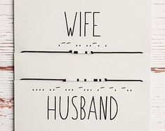 two white cards with the words wife and husband written in black ink on them next to each other