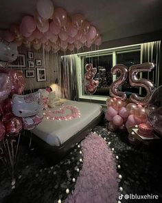 a bedroom decorated in pink and white balloons