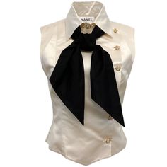 Chanel Ivory Silk Sleeveless Blouse With Black Tie Neck Condition: Very Good Condition Fabric Content: 100% Silk Care: Dry Clean Country Of Origin: France Color: Ecru Closure / Opening: Front Buttons Size Us 8 / Fr 40 (Runs Small, See Measurements) Bust 18.25" Waist 15.5" Hip 16.25" Length 19" Material: Silk Category: Clothing Subcategory: Tops Sub Sub Category: Blouses 30274-11 S1024ma ** Photos Are Of The Actual Item ** ** Roundabout Couture Certified Authentic ** Chanel Blouse Classy, Elegant Silk Sleeveless Vest, Classic Sleeveless Formal Blouse, White Formal Sleeveless Top, Elegant Fitted Silk Vest, Cream Sleeveless Formal Top, Designer Sleeveless Silk Top, Cream Sleeveless Top For Formal Occasions, Chic Fitted Silk Vest