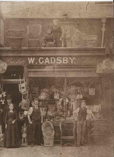 an old black and white photo of people in front of a store