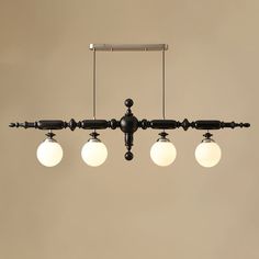 an old fashioned chandelier with five globes hanging from it's ceiling