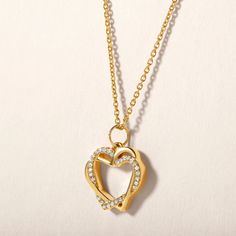 Crafted in 2.58 grams of 14K Yellow Gold, the necklace features 29 stones of Natural Diamonds with a total weight of 0.05 carats, graded as E-F color and I1-I2 clarity. The details have been verified by an independent laboratory, and a certificate of authenticity will be included with the shipment. Yellow Gold Double Heart Cubic Zirconia Necklace, Double Heart Cubic Zirconia Yellow Gold Necklace, Yellow Gold Heart Necklace With Brilliant Cut Pendant, Yellow Gold Heart-shaped Diamond Necklace, Yellow Gold Heart Pendant Charm Necklace, Fine Jewelry, Heart-shaped Yellow Gold Brass Necklace, Yellow Gold Diamond-cut Heart Pendant Necklace, Heart Love, Diamond Heart