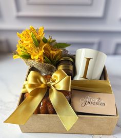 a gift box filled with coffee, doughnuts and flowers