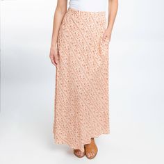 A summer essential, the Halle Maxi Skirt features a gorgeous amber floral pattern, comfortable elastic waistband, and pockets. This lightweight and easy to wear skirt will easily become your new favorite. Perfect as a boho summer skirt for women thanks to the soft flowing material and the soft color. Endless versatility and unfettered comfort make this the maxi skirt you'll reach for time and time again! On casual days, work days, nights out, date nights, to parties, this ankle length skirt will Casual Floral Print Skirt For Vacation, Patterned Lined Skirt For Beach, Patterned Lined Skirt For The Beach, Beach Patterned Lined Skirt, Casual Beach Maxi Skirt With Lining, Patterned Skirt For Vacation In Spring, Patterned Skirt For Spring Vacation, Patterned Long Skirt For Summer, Casual Maxi Skirt With Elastic Waistband For Beach