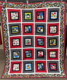 a red and black quilt with pictures on it