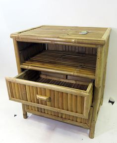 a wooden cabinet with two drawers sitting on top of it's sides and one drawer open