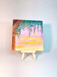 a small easel with a painting on it