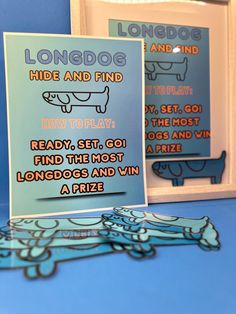 two greeting cards with the words long dog and hide and find in front of them