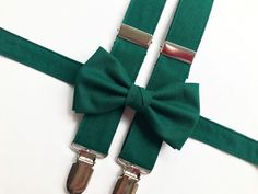 "Emerald green bow tie and suspenders, perfect for special occasions, wedding, birthdays, photo shoots or anything in between. To see more colours and patterns you can follow this link https://www.etsy.com/shop/canazacreations All bow ties are handmade with 100% cotton. All lovingly sewn with double bow and adjustable straps made from the same material as the bow. Baby and toddler bow ties are fastened with a 3 inch touch fastener to allow for size adjustment as your child grows. Child and adult sizes are fastened using metal hook and eye with slide adjuster.  Bow tie sizes are as follows Baby and Toddler (6 months - 5 years)  -  bow 3.5\"  neck strap up to 14\" Child  (5 + years) -  bow 4\"  neck strap up to 14\" Standard  -  bow 4.5\"  neck strap up to 20\" Large  -  bow 5\"  neck strap Emerald Green Ring Bearer Fall, Emerald Ring Bearer, Green Wedding Accessories, Emerald Green Suspenders And Bow Tie, Green Bow Ties For Wedding, Classic Green Bow Tie For Gifts, Emerald Green Suspenders, Emerald Green Bow Tie, Adjustable Green Bow Tie For Wedding