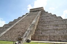 an ancient building with steps leading up to it's top and another structure in the background