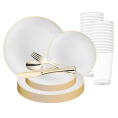 a stack of white plates with gold rims and forks next to a stack of clear cups