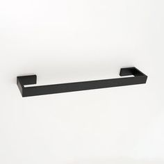 a black shelf mounted to the side of a wall