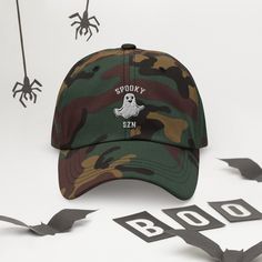 The only hat you need this fall for Halloween/Spooky SZN! Rock this adorable ghost cap with our matching Spoozy SZN sweatshirt: https://quebonito.shop/products/spooky-szn-unisex-sweatshirt • 100% chino cotton twill • Green Camo color is 35% chino cotton twill, 65% polyester • Unstructured, 6-panel, low-profile • 6 embroidered eyelets • 3 ⅛” (7.6 cm) crown • Adjustable strap with antique buckle • Blank product sourced from Vietnam or Bangladesh This product is made especially for you as soon as y Spooky Szn, Camo Colors, Halloween Spooky, Shop Products, Green Camo, Dad Hat, Trucker Cap, Need This, Dad Hats