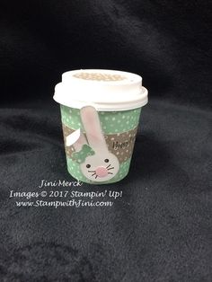 a coffee cup with a rabbit on it's side and the lid is empty