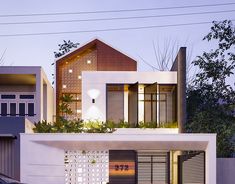 a car parked in front of a house with plants on the roof and side windows