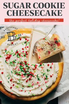 a cake with white frosting and sprinkles sitting on top of a plate