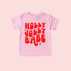 Holly Jolly Babe Christmas Shirt Feature Picture is a Pink Tee with Red Design Wash: For best results wash inside out on cold and line dry. DO NOT IRON directly on the image All our designs are printed with high quality heat transfer vinyl. The designs are applied using a professional commercial grade heat press and are made to last. All items are made to order in the order in which they are received so please allow 5 business days for your order to be shipped out. Business days include: Monday Cute Red T-shirt For Winter, Cute Red Winter T-shirt, Christmas Pink Cotton Tops, Pink Cotton Christmas Tops, Playful Red Christmas Tops, Cute Red Holiday Tops, Playful Cotton Holiday Tops, Playful Cotton Tops For The Holiday Season, Red Short Sleeve Holiday Top