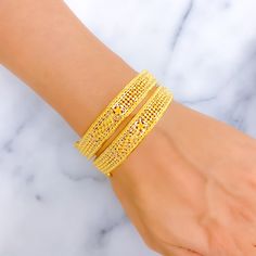 This pair of bangles is masterfully crafted from 22k gold, totaling 35.5 grams, and polished to a high shine in yellow gold. The bangles are each sized at 2.5 inches with a practical opening diameter of 2.3 inches, ensuring a snug fit for easy wear. The design features a subtle, flowy leaf pattern that adds a natural and graceful touch to the classic gold bangle. Each bangle is openable, equipped with a screw and hinge mechanism for secure closure and convenience. Ideal for those who appreciate the beauty of nature-inspired jewelry, these bangles offer a refined aesthetic that complements both formal attire and casual looks, perfect for everyday elegance or special occasions. PRODUCT DETAILS Gold Purity(karat): 22k Gold Weight(grams): 35.5 Item Finish: Yellow Gold Bangle Size: 2.5 Bangle O 22k Gold Bangles, Bridal Jewelry Necklace, Precious Stones Rings, Diamond Pendant Sets, The Bangles, Modern Bracelets, Refined Aesthetic, Yellow Gold Bangle, Fancy Necklace