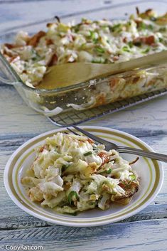 a casserole dish with coleslaw and bacon in it on a plate