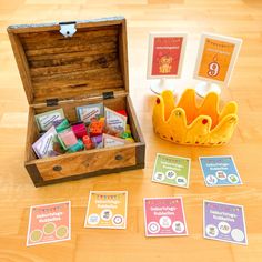 an open wooden box filled with lots of different items on top of a wood floor