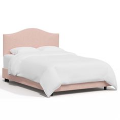 a bed with a pink upholstered headboard and white sheets on top of it