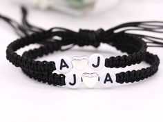 two bracelets with hearts and the word jaja written on them are sitting next to each other