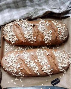 two loaves of bread with sesame seeds on top