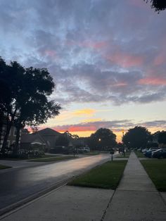 the sun is setting over a residential neighborhood