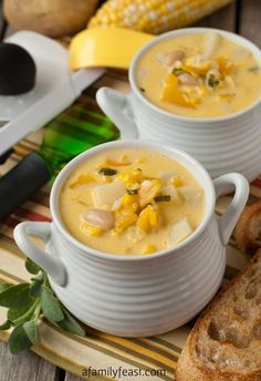 two white bowls filled with corn and cheese soup