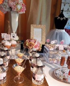 a table topped with lots of cupcakes and desserts on top of it