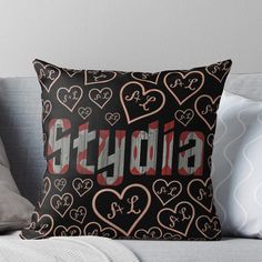 a black and red throw pillow with the word stencil on it in hearts