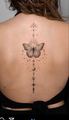 a woman's back with a butterfly tattoo on it