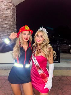 two women dressed in costumes posing for the camera