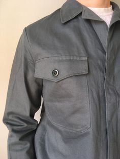 Deadstock Size - S Vintage German Workwear Jacket  Chore Coat Sanfor MoleskinThis vintage worker`s  jacket is in wonderful  deadstock condition- name brand - Leber- made in Germany- color – grey- 2 outside pockets - 2 button on the cuffs- 4 buttons at front- material - cotton- label size - 46 (watch measurements)FLAT Measurements:Shoulders : 6 (15cm)Chest (underarm to underarm) : 21 inches (53cm)Sleeve : 24 inches (61cm)Length(back) : 25 inches (64cm)Pay your attention to that  most antique item Fitted Utility Jacket With Welt Pockets, Fitted Utility Jacket With Patch Pockets, Utility Jacket With Lapel Collar For Work, Collared Utility Jacket With Patch Pockets For Work, Collared Utility Jacket For Workwear, Button-up Utility Jacket With Pockets For Work, Fitted Utility Jacket With Lapel Collar, Khaki Utility Jacket With Lapel Collar For Work, Khaki Utility Jacket With Welt Pockets For Work