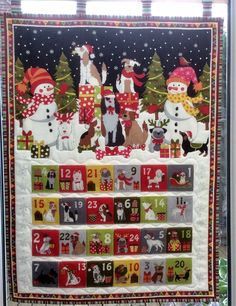 a quilted christmas calendar with dogs and presents on the front, surrounded by snowmen