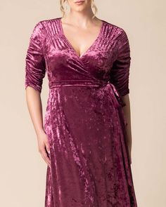 a woman wearing a purple velvet dress