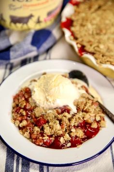 a dessert with ice cream and strawberries is on a plate next to a pie