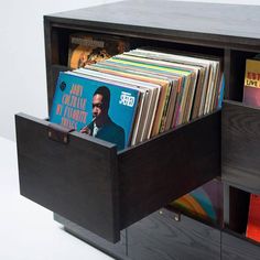 a record player's storage unit with vinyl records in it